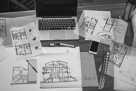 Novelty Moodboard: Blueprints and laptop on a desk